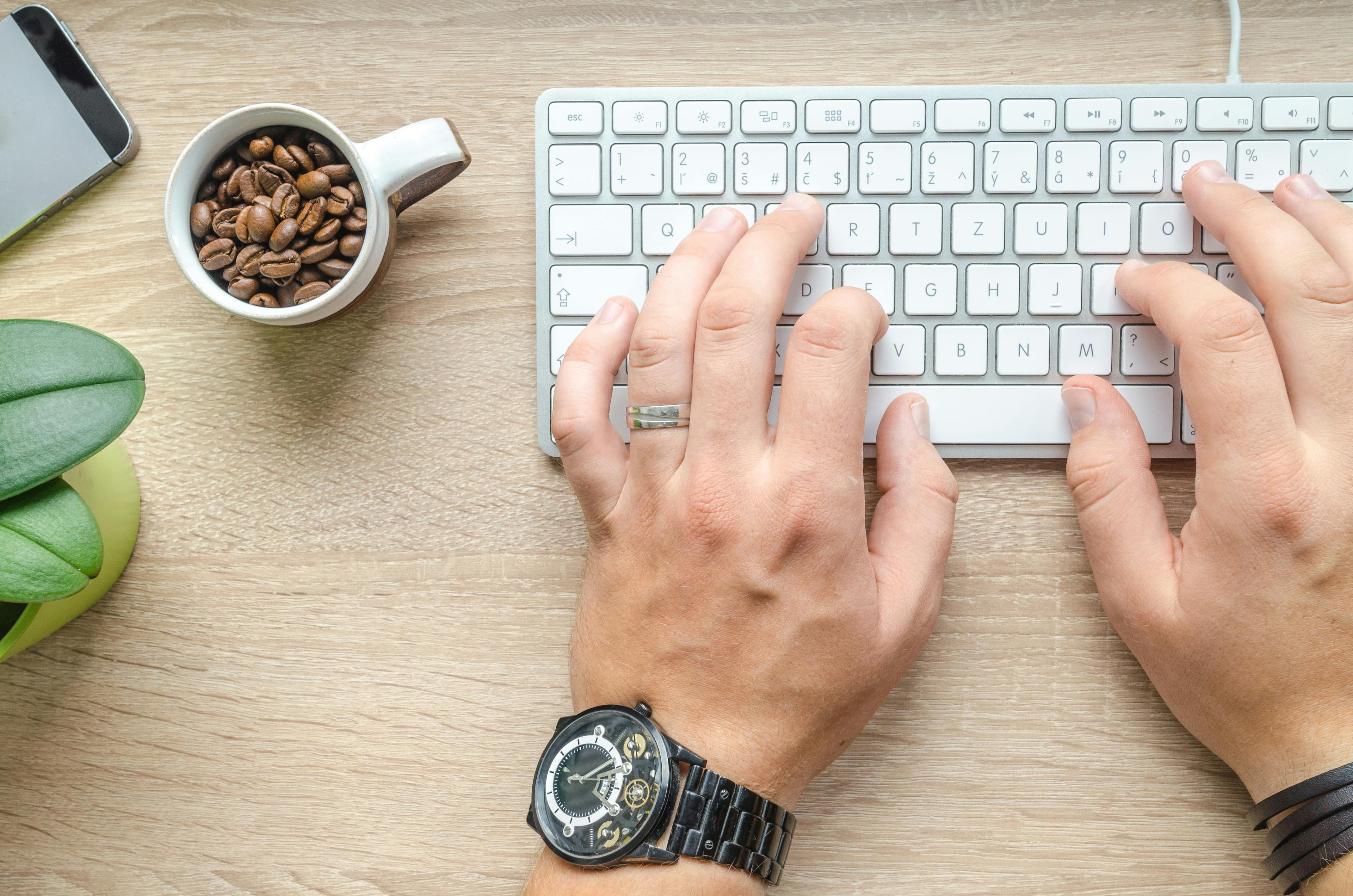 A picture of smartphone with a user typing on it